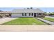 Charming single-story home featuring a lush green lawn and tidy landscape at 1021 S Almar Cir, Mesa, AZ 85204