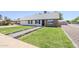 Home featuring an expansive green lawn and landscaped walkway to the front door at 1021 S Almar Cir, Mesa, AZ 85204
