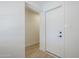 Bright hallway with an exterior door and a neutral color scheme at 1021 S Almar Cir, Mesa, AZ 85204