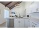 Spacious kitchen featuring stainless steel appliances, white cabinets and quartz countertops at 1021 S Almar Cir, Mesa, AZ 85204