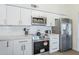 Well-equipped kitchen featuring stainless steel appliances and sleek white cabinetry at 1021 S Almar Cir, Mesa, AZ 85204