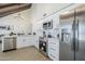 Modern kitchen with stainless steel appliances, white cabinets, and quartz countertops at 1021 S Almar Cir, Mesa, AZ 85204