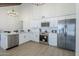 Bright kitchen with stainless steel appliances, white cabinets, and modern lighting at 1021 S Almar Cir, Mesa, AZ 85204
