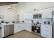 Modern kitchen with stainless steel appliances and stylish white cabinets and countertops at 1021 S Almar Cir, Mesa, AZ 85204