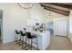 Bright kitchen boasts an island with seating and features stainless steel appliances and modern pendant lighting at 1021 S Almar Cir, Mesa, AZ 85204
