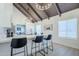 Kitchen features a quartz countertop island with seating and a dining area view, illuminated by chandelier lighting at 1021 S Almar Cir, Mesa, AZ 85204