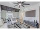 Open-concept living space with wood-beam ceiling, modern furnishings, and light wood floors at 1021 S Almar Cir, Mesa, AZ 85204