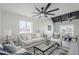Comfortable living room features a modern ceiling fan, stylish rug, and bright natural light at 1021 S Almar Cir, Mesa, AZ 85204