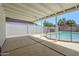 This covered patio features a view of the sparkling pool and block fence at 1021 S Almar Cir, Mesa, AZ 85204