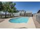 Backyard with a refreshing in-ground pool, landscaped with rocks and greenery at 1021 S Almar Cir, Mesa, AZ 85204