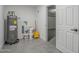 This storage room features gray epoxy floors, storage and a water heater at 1021 S Almar Cir, Mesa, AZ 85204