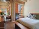 Stylish bedroom featuring a bed, a bench, and exposed brick, with an open view to the living area at 114 W Adams St # 505, Phoenix, AZ 85003