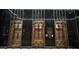Ornate elevator doors with architectural details and black marble backdrop in the lobby at 114 W Adams St # 505, Phoenix, AZ 85003