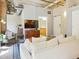 This living room features concrete ceilings, modern decor and is adjacent to the bathroom at 114 W Adams St # 505, Phoenix, AZ 85003