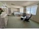 Spacious bedroom with chair and dresser. Multiple windows, as well as a large bed at 120 N Val Vista Dr # 272, Mesa, AZ 85213