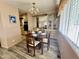 Cozy dining room features a dark wood table, laminated flooring, and natural light at 120 N Val Vista Dr # 272, Mesa, AZ 85213
