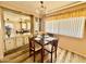 Cozy dining room features a dark wood table, laminated flooring, and natural light at 120 N Val Vista Dr # 272, Mesa, AZ 85213
