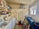 Functional laundry room with washer, dryer, shelving, and cleaning supplies at 120 N Val Vista Dr # 272, Mesa, AZ 85213