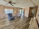 Well-lit living room with laminate flooring, neutral paint, and comfortable seating at 120 N Val Vista Dr # 272, Mesa, AZ 85213