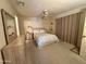 Cozy bedroom with ample natural light, ceiling fan, carpeted floor, and dresser with mirror at 120 N Val Vista Dr # 272, Mesa, AZ 85213