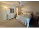 Comfortable bedroom with a ceiling fan, carpeted floors, dresser with mirror and good lighting at 120 N Val Vista Dr # 272, Mesa, AZ 85213
