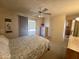 Bedroom with a ceiling fan, and access to the outdoors, dresser and view to kitchen at 120 N Val Vista Dr # 272, Mesa, AZ 85213