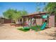 Large backyard with play structure, playhouse, garden beds and green turf at 1225 S 160Th Ln, Goodyear, AZ 85338