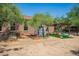 Large backyard with play structure and a custom-built playhouse and garden beds at 1225 S 160Th Ln, Goodyear, AZ 85338