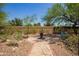 Landscaped backyard retreat with decorative stone pathway, plants, and outdoor seating at 1225 S 160Th Ln, Goodyear, AZ 85338