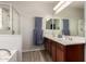 Bathroom featuring a double sink vanity, walk-in shower, and modern fixtures at 1225 S 160Th Ln, Goodyear, AZ 85338