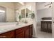 Well-lit bathroom featuring vanity with dual mirrors and granite counter and access to bedroom at 1225 S 160Th Ln, Goodyear, AZ 85338