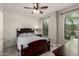 Cozy bedroom with decorative wall and ceiling fan with large windows offering natural light at 1225 S 160Th Ln, Goodyear, AZ 85338