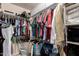 Organized walk-in closet featuring ample hanging space, shelving, and clothing, maximizing storage efficiency at 1225 S 160Th Ln, Goodyear, AZ 85338