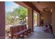 Relaxing covered patio overlooking landscaped backyard, perfect for enjoying the outdoors at 1225 S 160Th Ln, Goodyear, AZ 85338