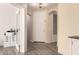 Inviting foyer featuring wood flooring, a white door, and a view into the office at 1225 S 160Th Ln, Goodyear, AZ 85338