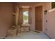Covered front porch featuring desert themed decor, stacked stone accents and modern steel front door at 1225 S 160Th Ln, Goodyear, AZ 85338