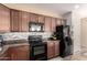 Traditional kitchen with brown cabinets, granite countertops, and stainless-steel appliances at 1225 S 160Th Ln, Goodyear, AZ 85338