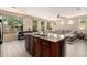 Spacious kitchen island featuring granite countertops and stainless-steel double sink at 1225 S 160Th Ln, Goodyear, AZ 85338