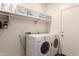 Well-organized laundry room equipped with washer, dryer and shelving at 1225 S 160Th Ln, Goodyear, AZ 85338