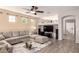 Bright and open living room featuring tile floors, modern furniture and neutral color palette at 1225 S 160Th Ln, Goodyear, AZ 85338