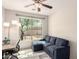 Relaxing living room area with a comfortable blue sofa near sunlit window at 1225 S 160Th Ln, Goodyear, AZ 85338