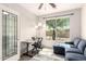 Well-lit office with a large window, a comfortable sofa, and a modern desk setup at 1225 S 160Th Ln, Goodyear, AZ 85338
