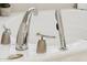 Close-up of bathtub fixtures including faucet, sprayer, and soap dispenser at 1228 E Mountain Vista Dr, Phoenix, AZ 85048