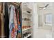 Walk-in closet leading to a primary bathroom featuring a tub and separate glass shower at 1228 E Mountain Vista Dr, Phoenix, AZ 85048