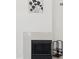 Close-up of a modern fireplace with tile surround and decorative fireplace tools at 1228 E Mountain Vista Dr, Phoenix, AZ 85048