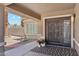 Inviting front porch with a patterned rug, potted plants, and decorative front door at 1228 E Mountain Vista Dr, Phoenix, AZ 85048