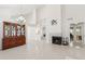 Open-concept living space with a fireplace, tile flooring, and a stylish display cabinet at 1228 E Mountain Vista Dr, Phoenix, AZ 85048