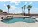 Lush backyard featuring a sparkling pool, rock water feature, desert landscaping, and privacy fencing at 1228 E Mountain Vista Dr, Phoenix, AZ 85048