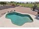 Aerial view of an inviting backyard pool with rock feature, desert landscaping and a view of the golf course at 1228 E Mountain Vista Dr, Phoenix, AZ 85048