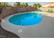 Backyard pool featuring a spacious patio with lounge chairs, steps, and privacy walls at 12374 W Hopi St, Avondale, AZ 85323